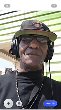 a man is wearing headphones and a hat