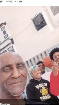 a picture of a family with a basketball hoop in the background